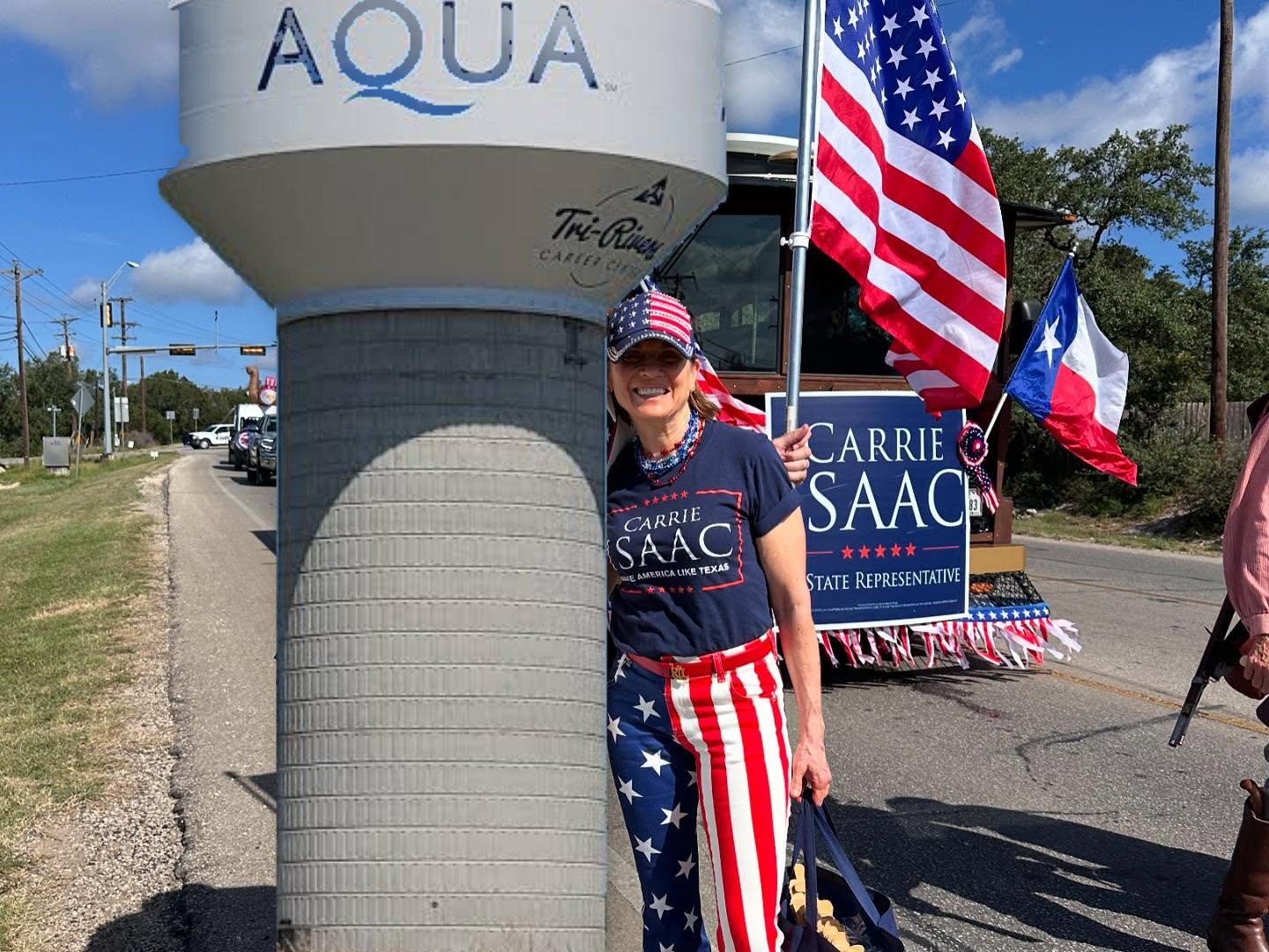 Carrie Isaac hugging an Aqua water tower at a parade